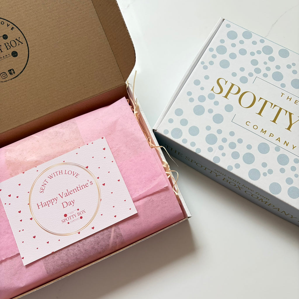 Box with pink interior and 'Happy Valentine's Day' card, next to 'The Spotty Company' branded box.