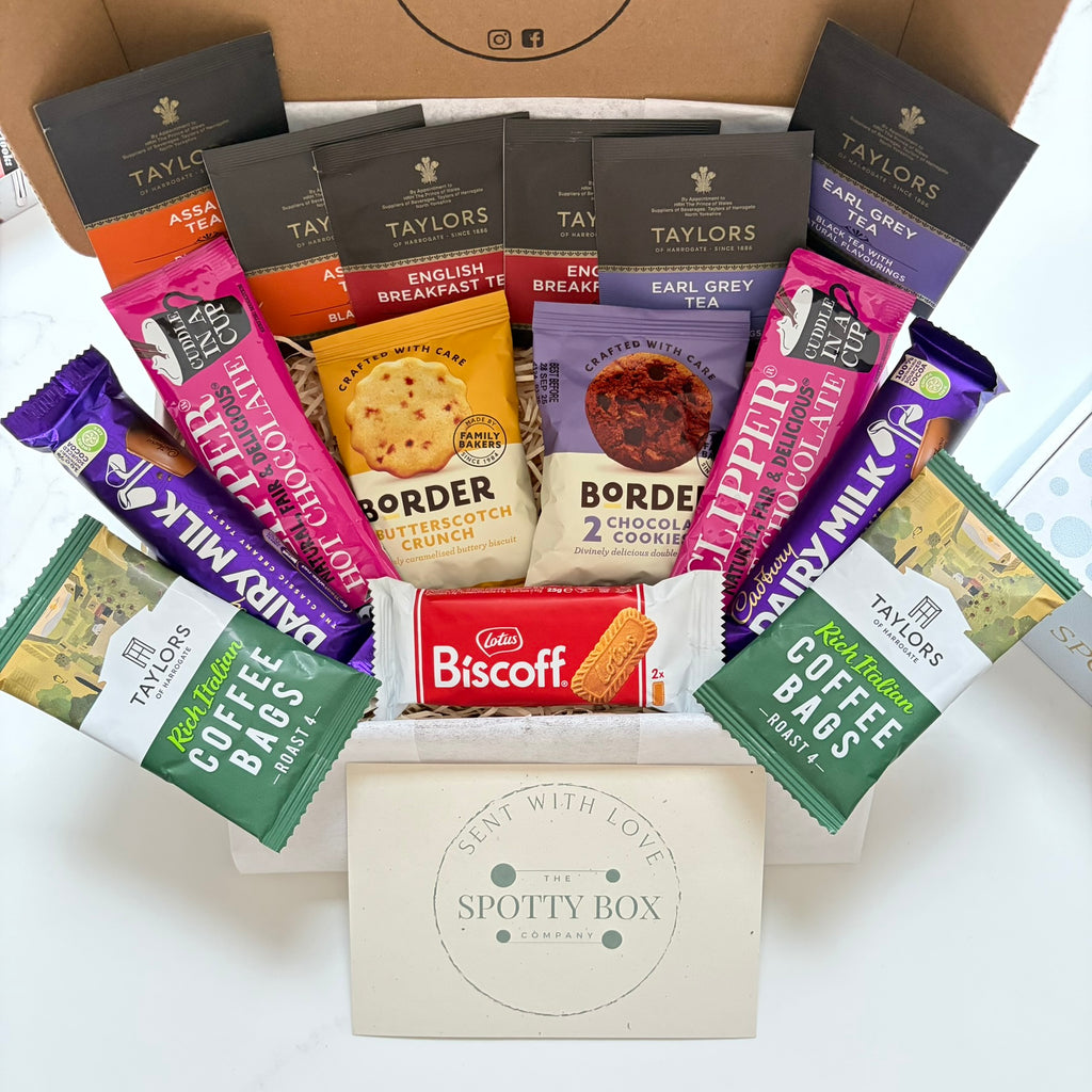 hot drink and biscuit gift hamper from the spotty box company containing taylors coffee sachets, taylors tea selection, border biscuits. cadbury dairy milk and clippers hot chocolate and a lotus biscoff biscuit. all presented in a tasteful 'spotty' box, ideal as a gift for tea and coffee lovers
