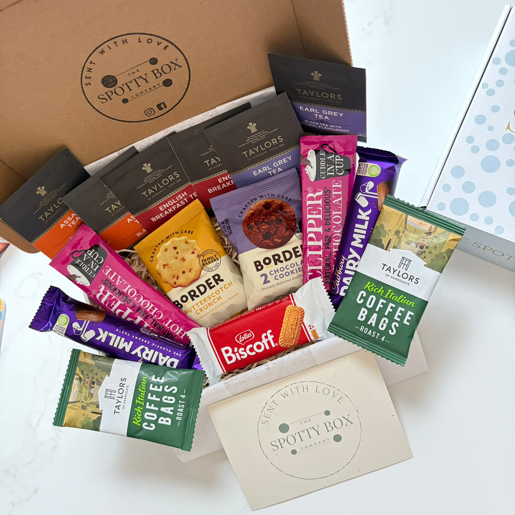 hot drink and biscuit gift hamper from the spotty box company containing taylors coffee sachets, taylors tea selection, border biscuits. cadbury dairy milk and clippers hot chocolate and a lotus biscoff biscuit. all presented in a tasteful 'spotty' box, ideal as a gift for tea and coffee lovers