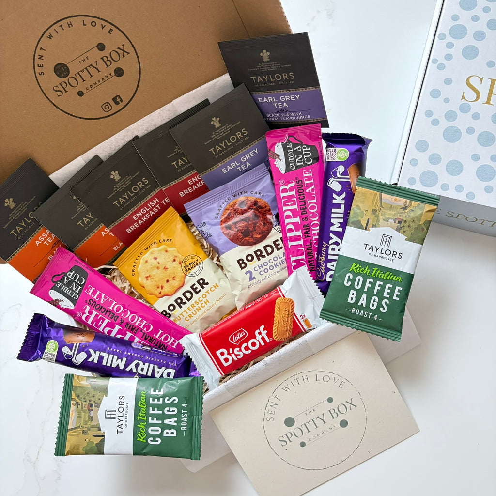 hot drink and biscuit gift hamper from the spotty box company containing taylors coffee sachets, taylors tea selection, border biscuits. cadbury dairy milk and clippers hot chocolate and a lotus biscoff biscuit. all presented in a tasteful 'spotty' box, ideal as a gift for tea and coffee lovers