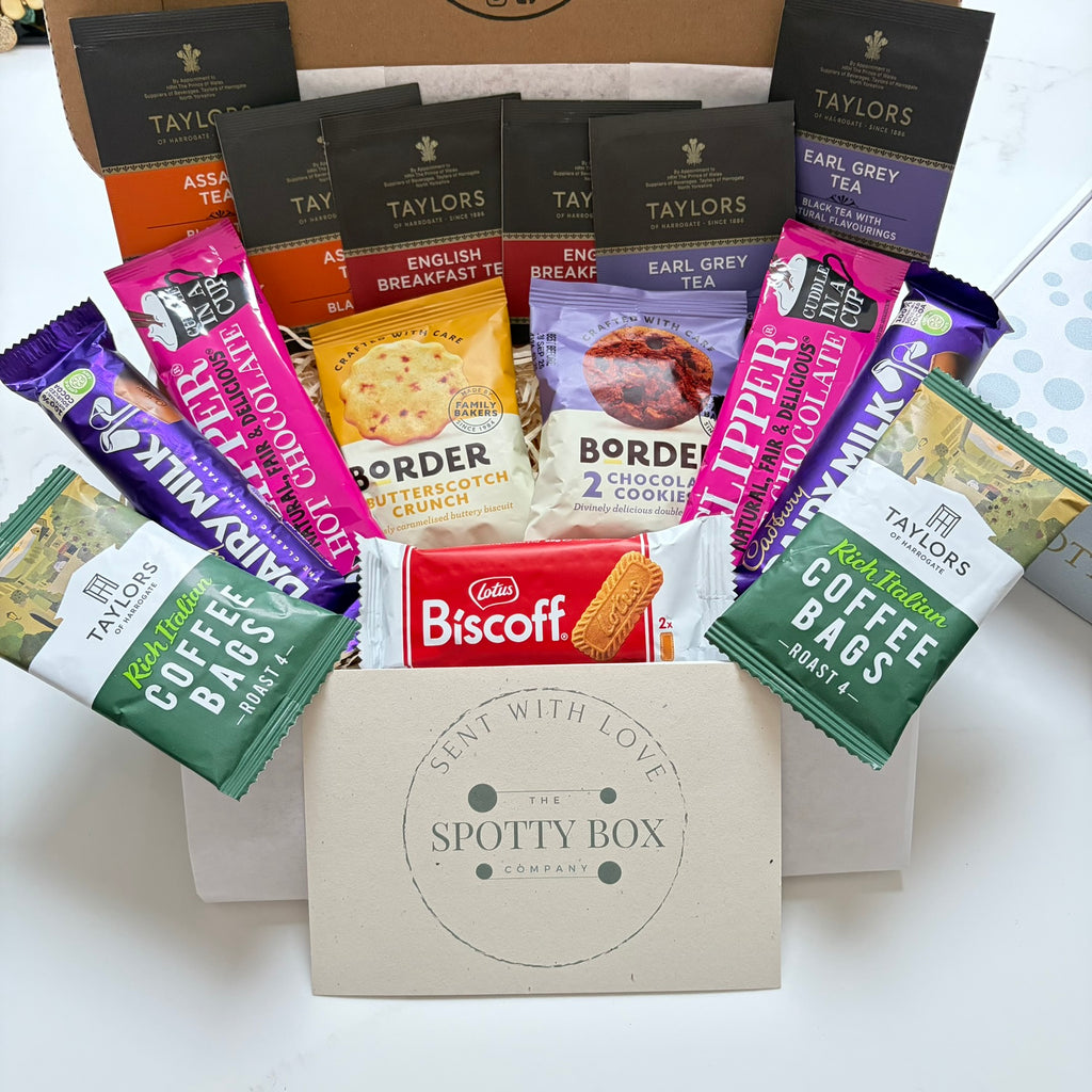 hot drink and biscuit gift hamper from the spotty box company containing taylors coffee sachets, taylors tea selection, border biscuits. cadbury dairy milk and clippers hot chocolate and a lotus biscoff biscuit. all presented in a tasteful 'spotty' box, ideal as a gift for tea and coffee lovers